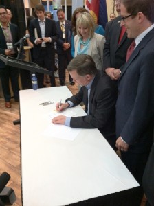 Colorado Governor John Hickenlooper signs a space-friendly bill at the 30th Space Symposium in Colorado Springs.