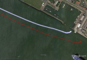 the red track  is based on raw eLoran data without any corrections. The transparent blue line is made by GPS-RTK and is widened to 10 meters, giving the required ± 5-meter limits of eDLoran. The white line is output from the eDLoran receiver, which stays within the borders of the 10-meter-wide transparent blue line.