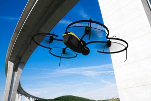 A Sensefly eXom UAV inspects a structure.
