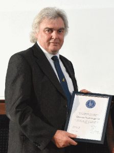 Charles Curry, founder of Chronos Technology, with the RIN award. (Photo: Chronos)