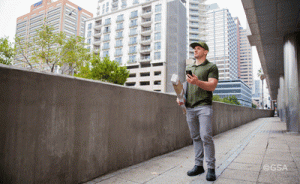 Delivery person uses Galileo on a mobile device to deliver a package. (Photo: GSA)