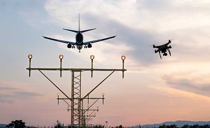 Conducting integrated drone surveys at a congested airport